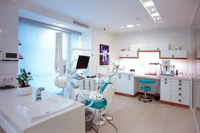 A dentist reviewing patient x-rays on a light board